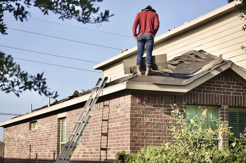 Professional roofer working on a residential roof in Ebenezer